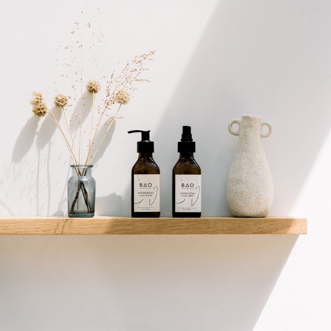BAO Refreshing Face Wash and Hydrating Face Mist bottles displayed on a shelf with dried flowers