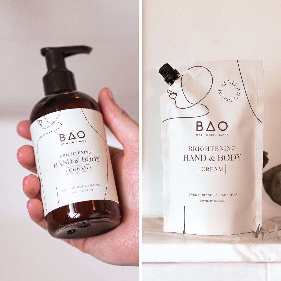 Hand holding BAO Brightening Hand & Body Cream bottle next to its refill pouch