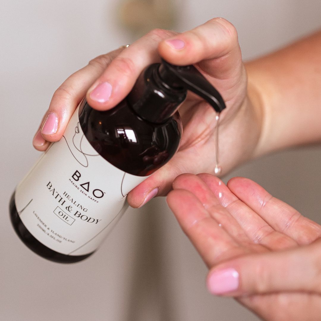 Pumping BAO Healing Bath & Body Oil from the bottle onto an open palm