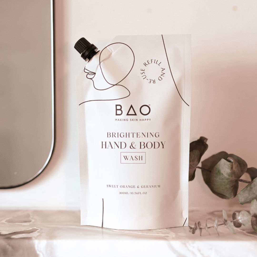 BAO Brightening Hand & Body Wash refill pouch standing on a marble bathroom shelf