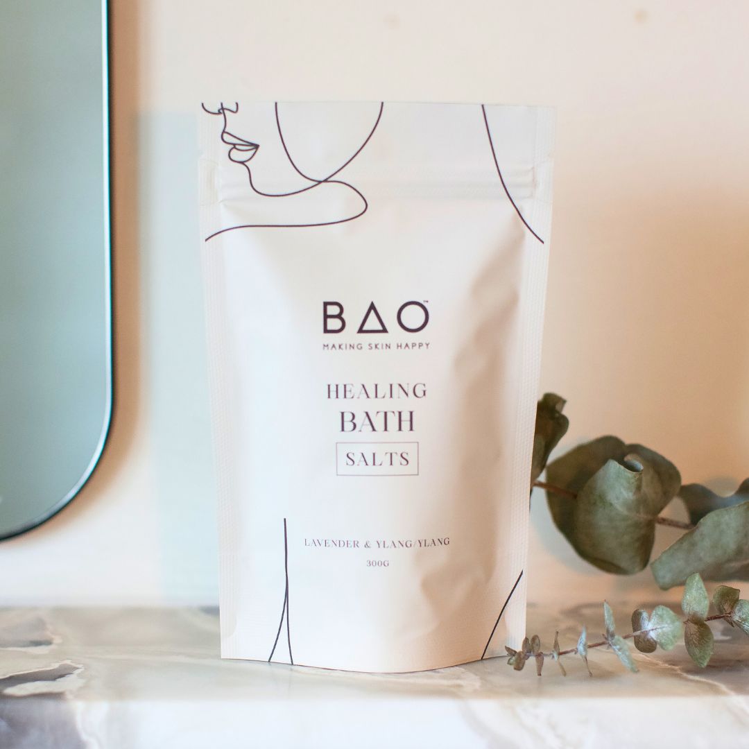 BAO Healing Bath Salts pouch displayed on a marble shelf with eucalyptus leaves