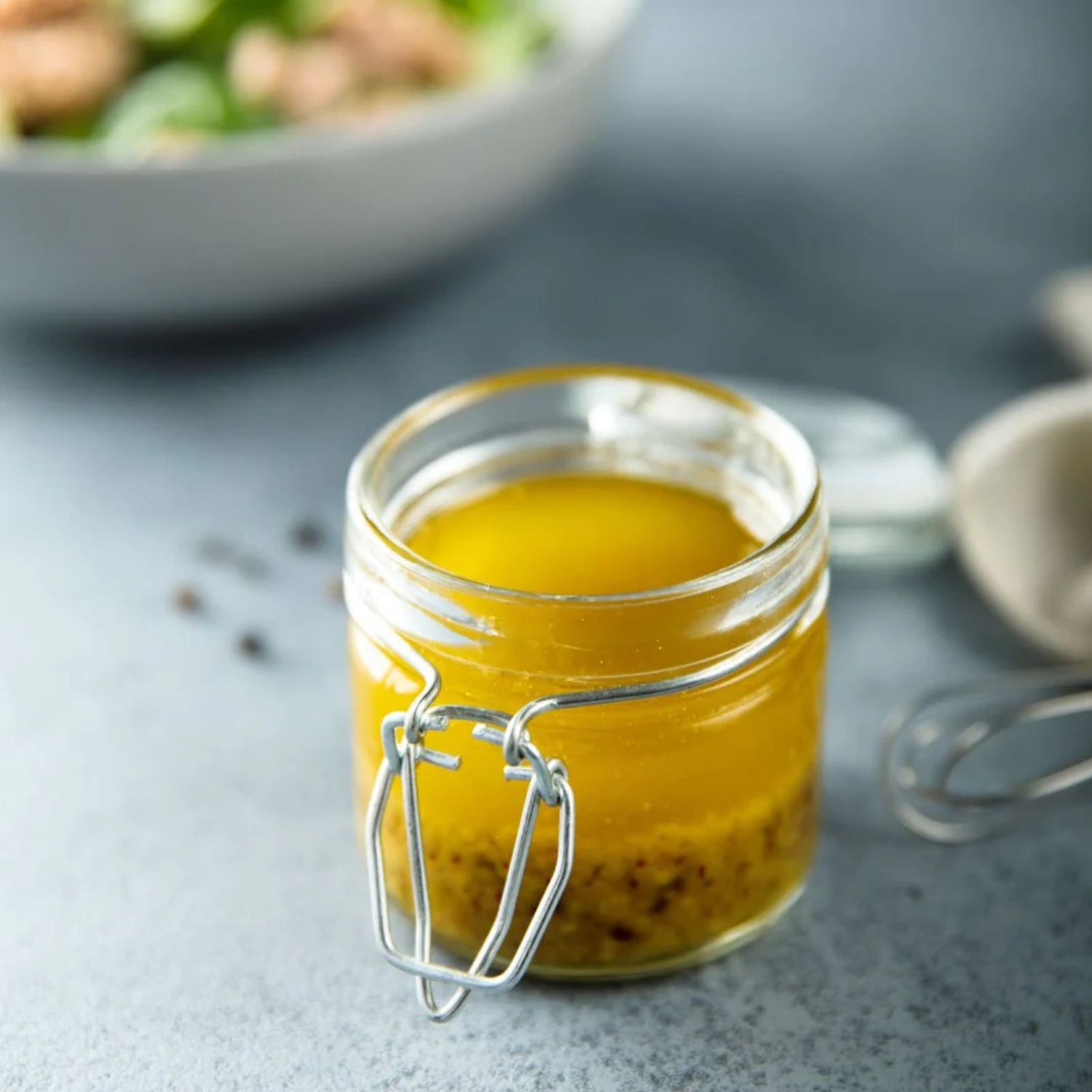Healthy salad dressing in a small recyclable glass jar