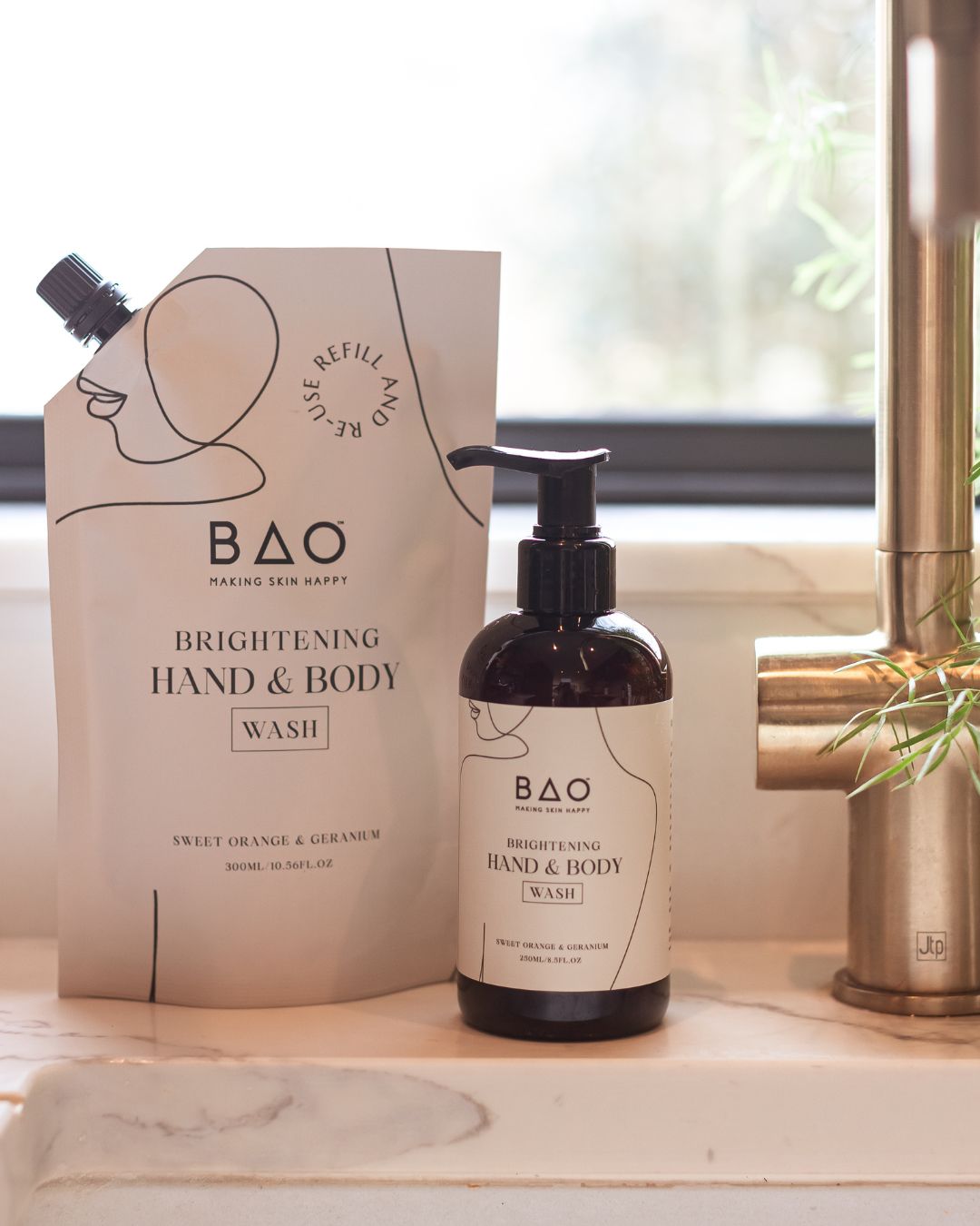 BAO Brightening Hand & Body Wash bottle and refill pouch on a bathroom sink counter