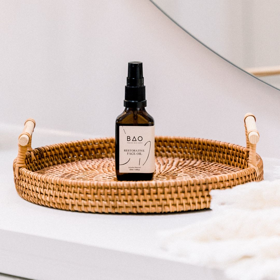 BAO Restorative Face Oil bottle displayed on a woven tray