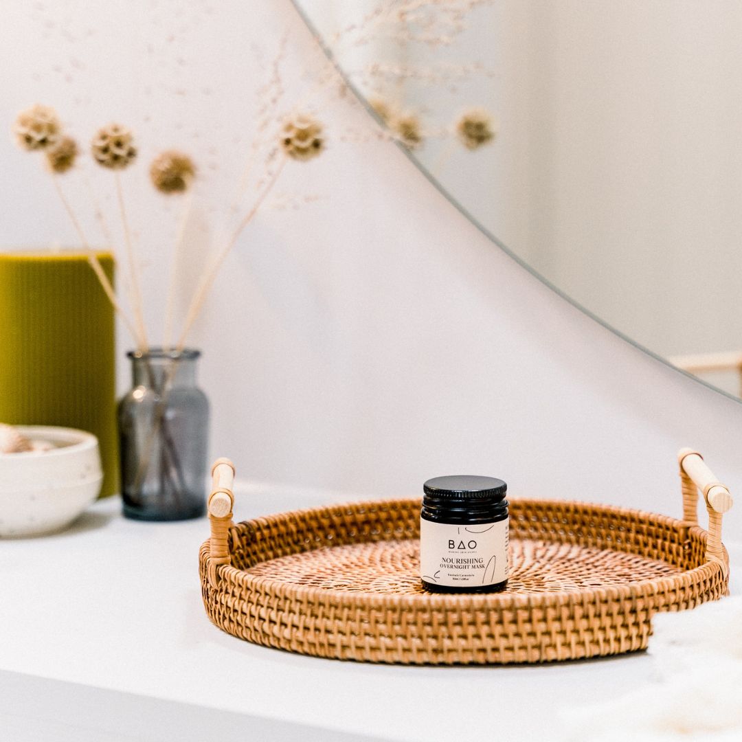 BAO Nourishing Overnight Mask jar displayed on a woven tray with dried flowers