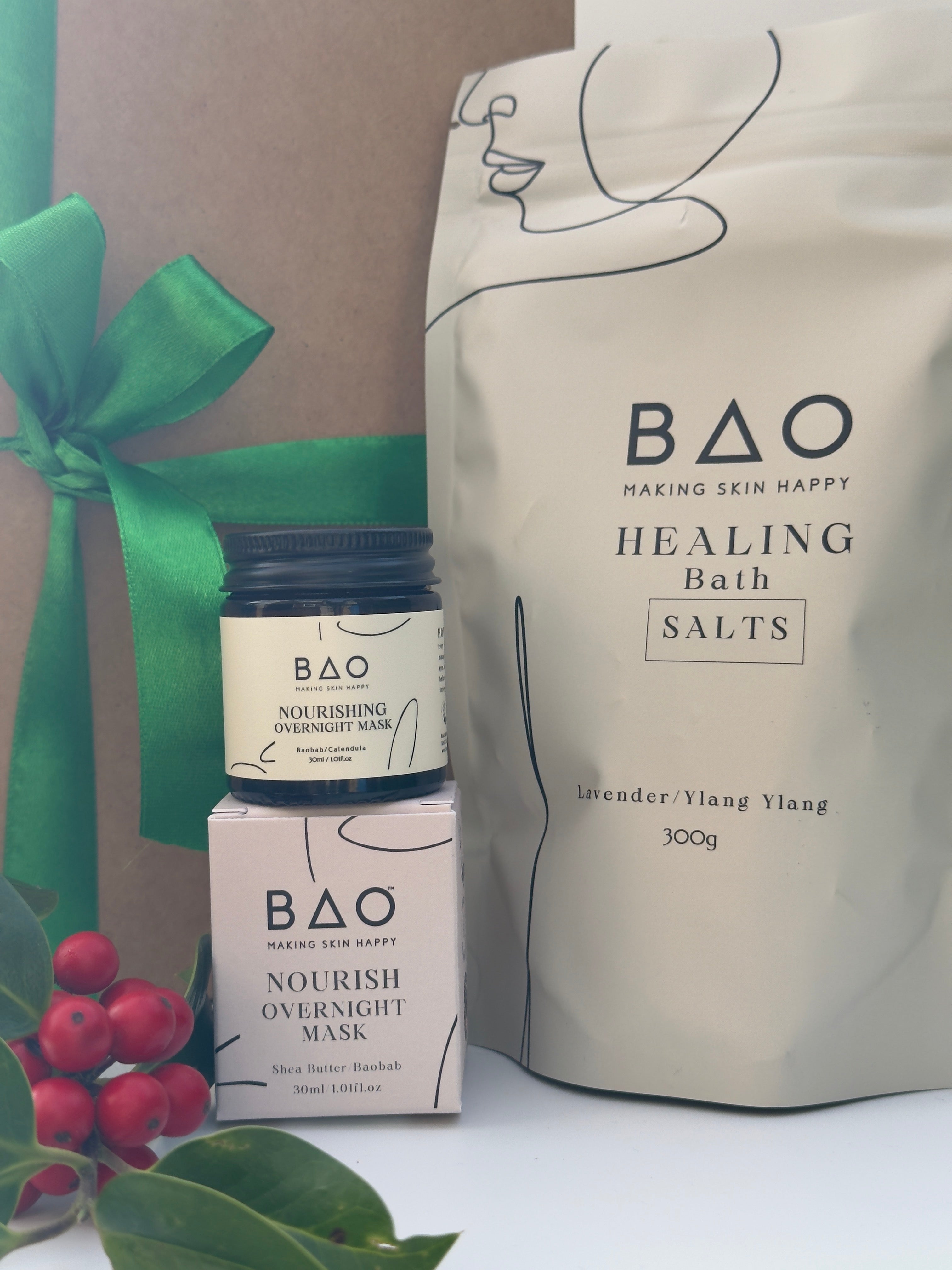 BAO Healing Bath Salts packaging with a green ribbon and berries on a white background
