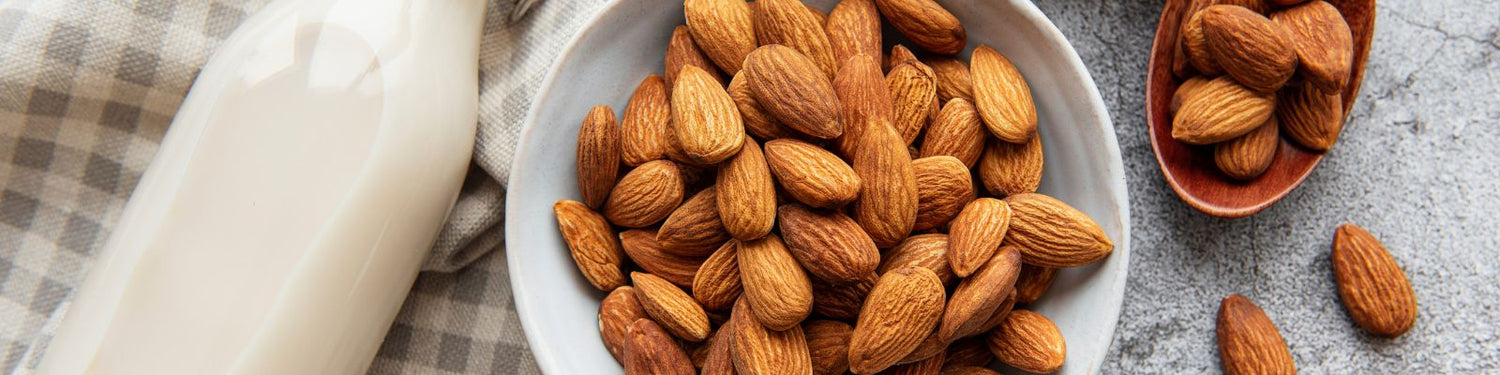 Organic almond milk and bowl of whole almonds