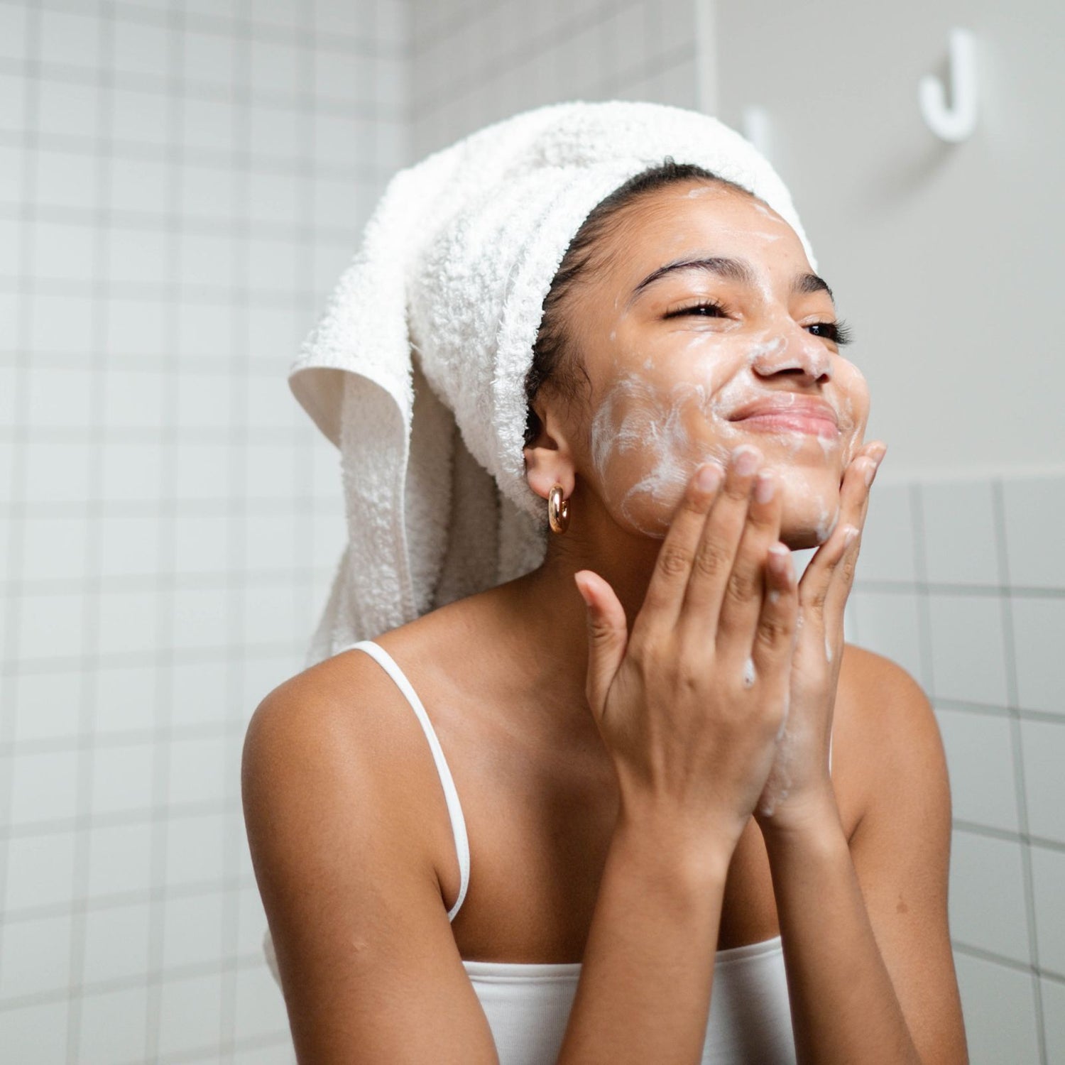 Woman washing face with eco-friendly vegan face wash.